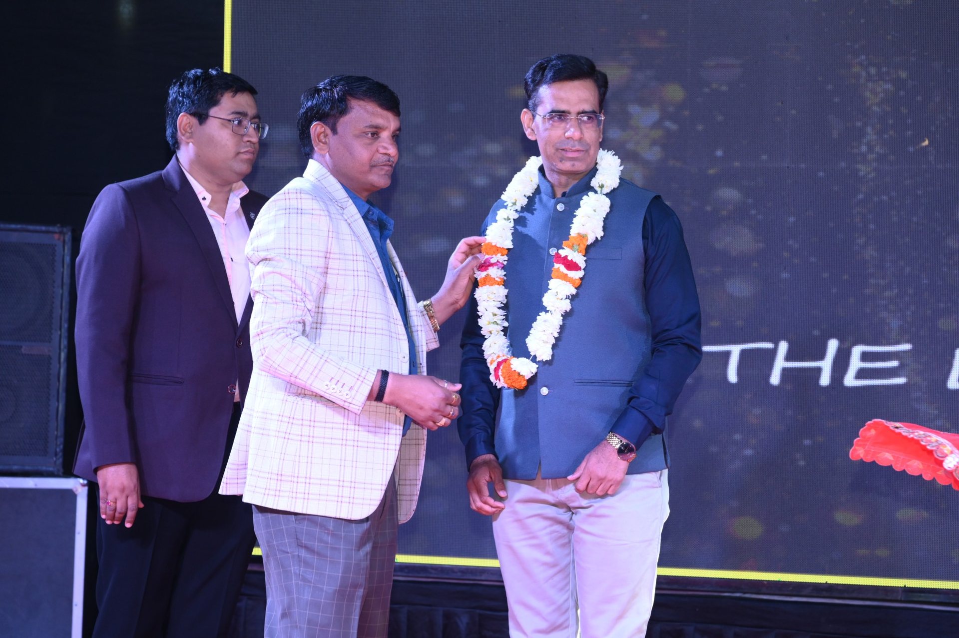 Felicitating a guest with a floral garland